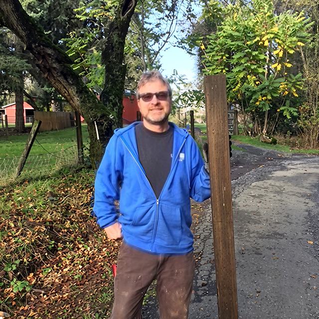 Person holding fence post installation