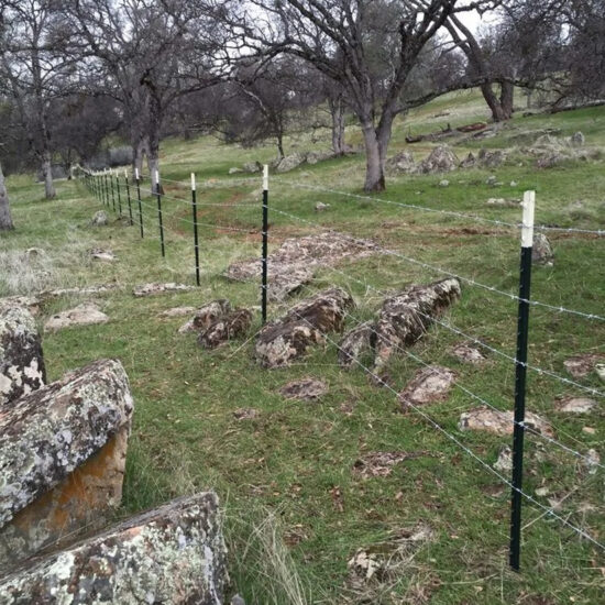 Wire fence installation on hillside