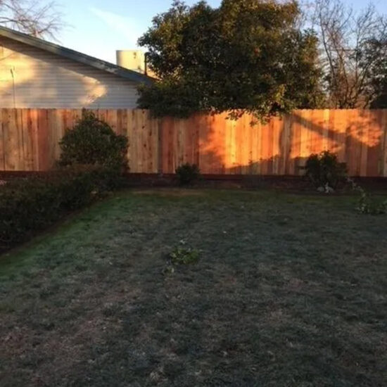 Backyard wooden privacy fence installation