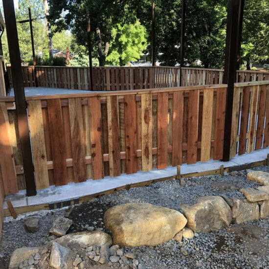 New wooden fence installation backyard