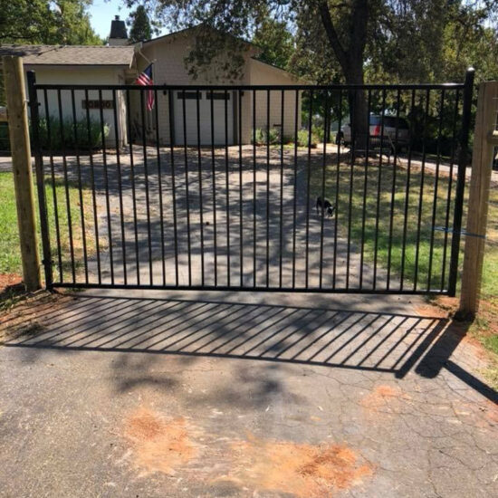 Metal driveway gate installed fence