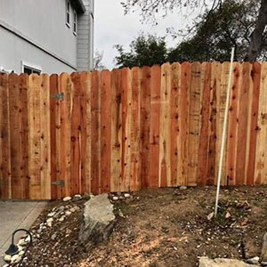 New wooden fence installation backyard