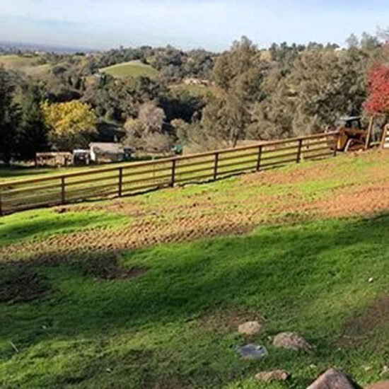Wood ranch fence installation hillside