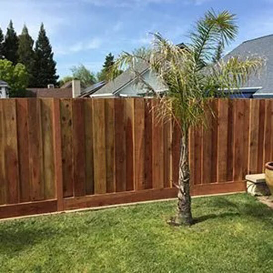 New wooden fence installation backyard