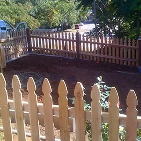 Wood picket fence installation yard